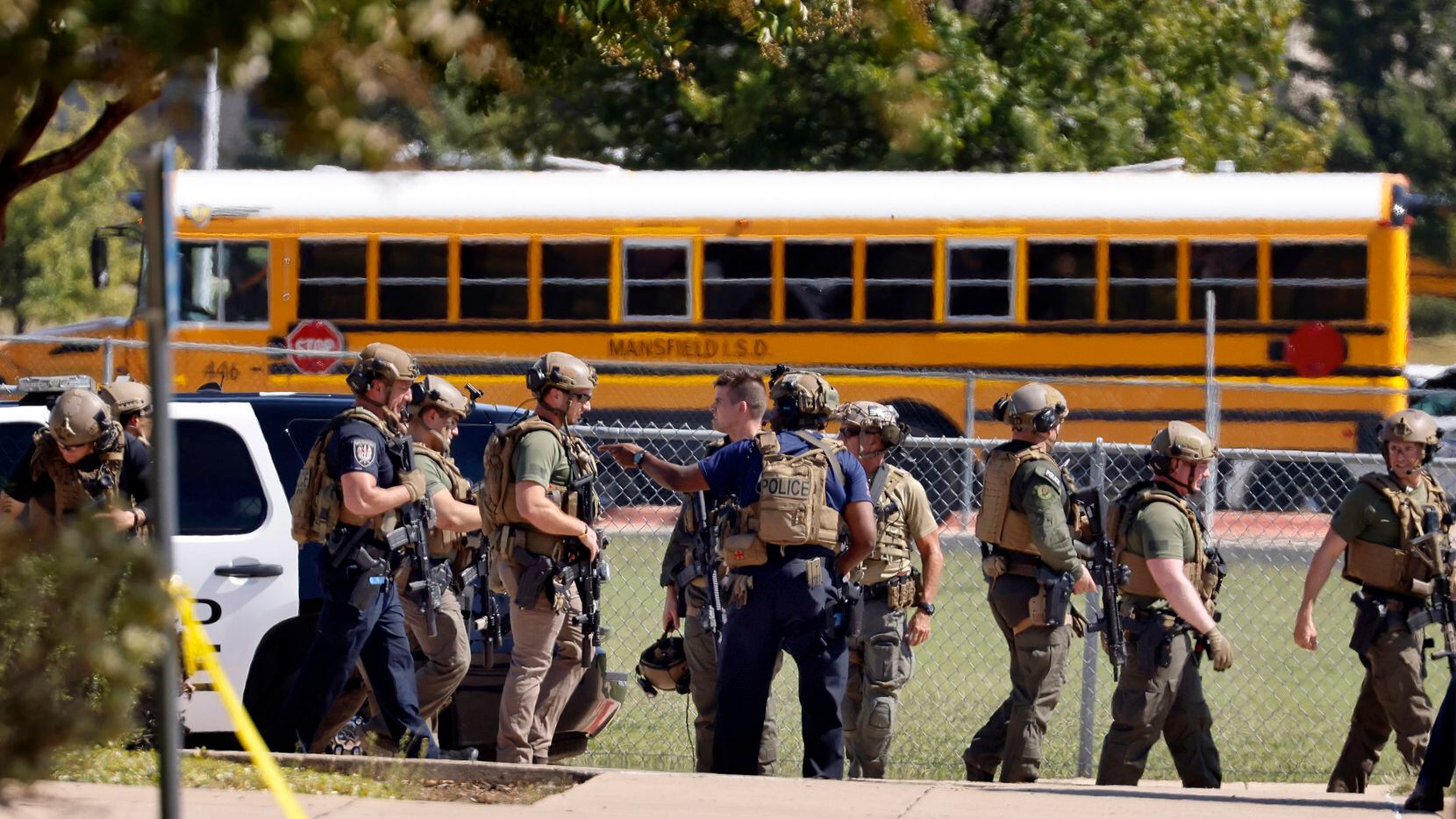 Tactical officers clear the scene following a shooting inside Mansfield Timberview High School in Arlington, Texas, Wednesday, October 6, 2021. Four people were injured in the shooting and the suspect turned himself into the Arlington police. (Tom Fox/The Dallas Morning News) 