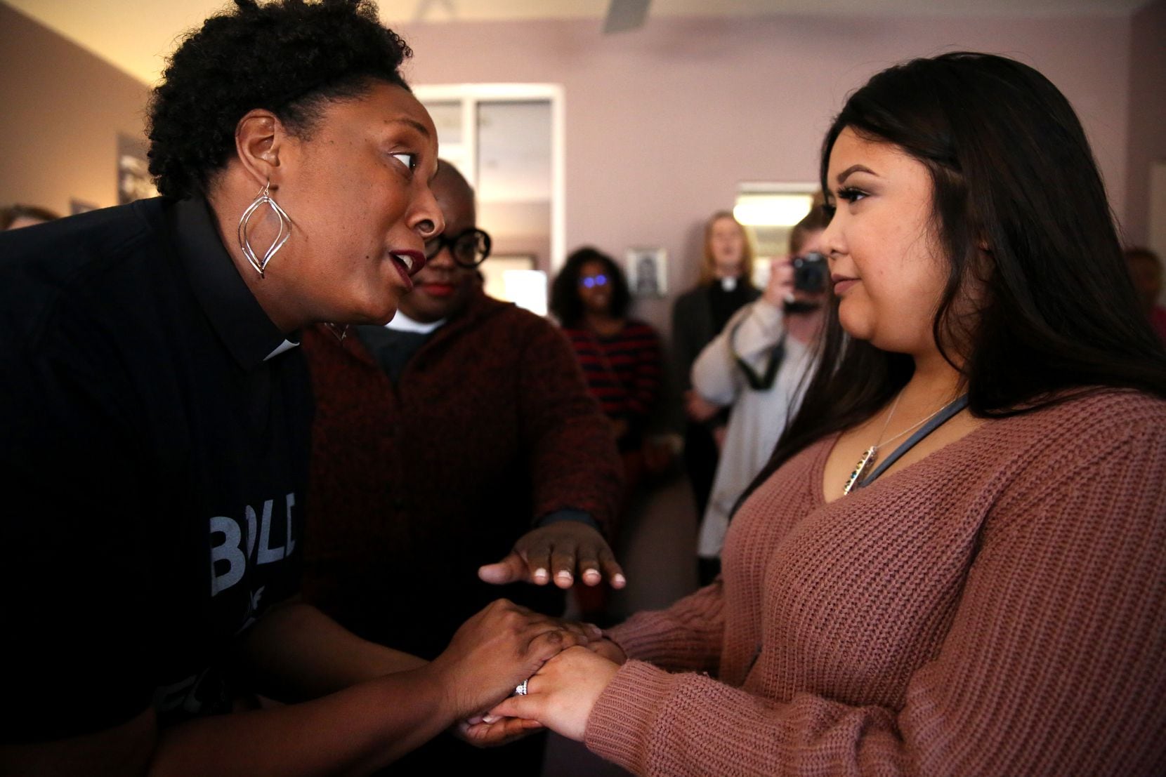 Kentina Washington-Leapheart (left), director of programs for reproductive justice and sexuality education at the Religious Institute, gives an oil blessing to Tiffany Romero, a medical assistant, during a ceremony at the Whole Woman's Health clinic in Fort Worth, Texas on Thursday, Nov. 9, 2017. (Rose Baca/The Dallas Morning News)
