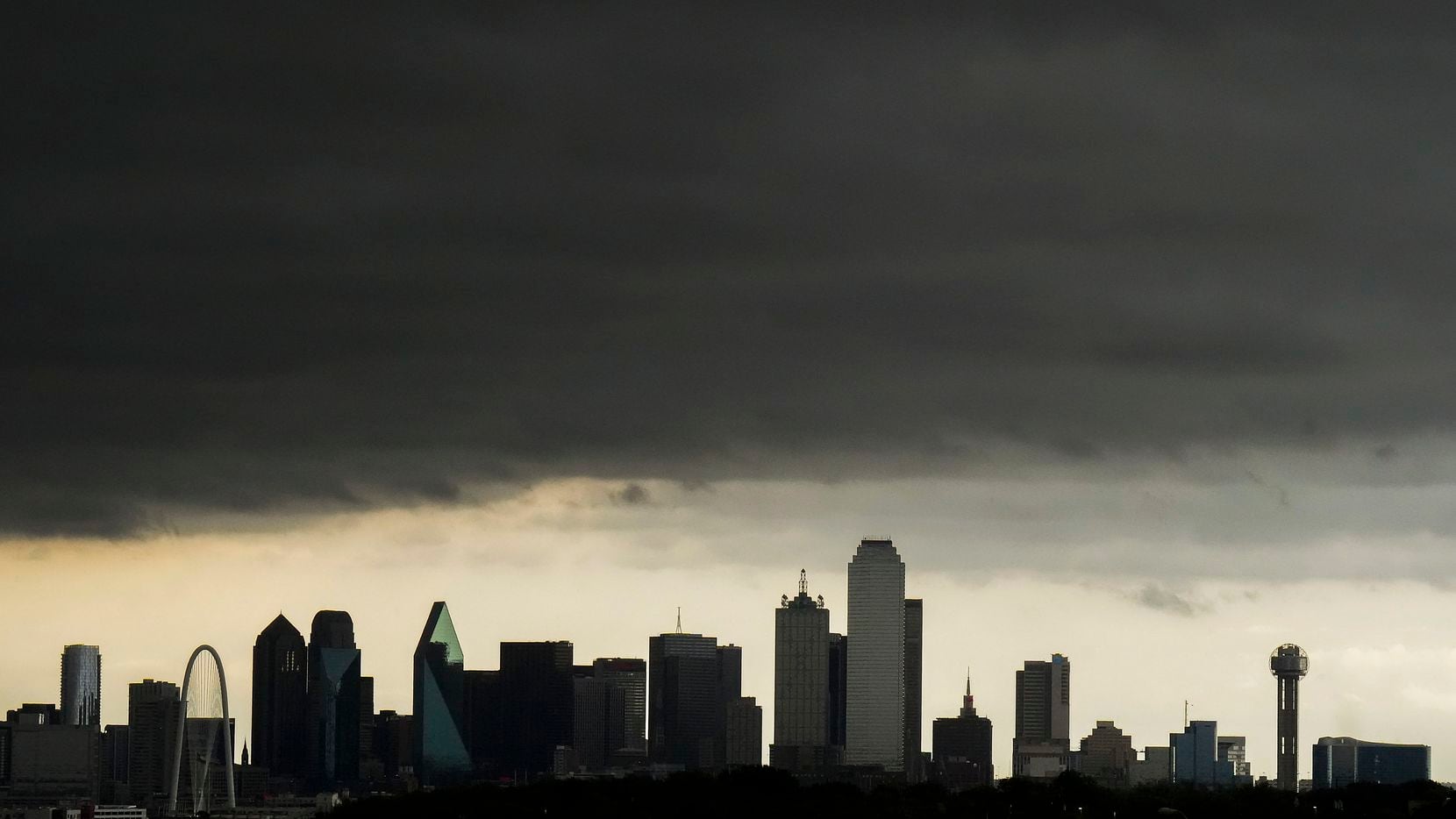 Storm clouds roll over the downtown skyline as severe storms move through North Texas.