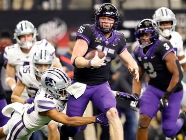 TCU Horned Frogs quarterback Max Duggan (15) caries the ball as he’s tackled by Kansas State...