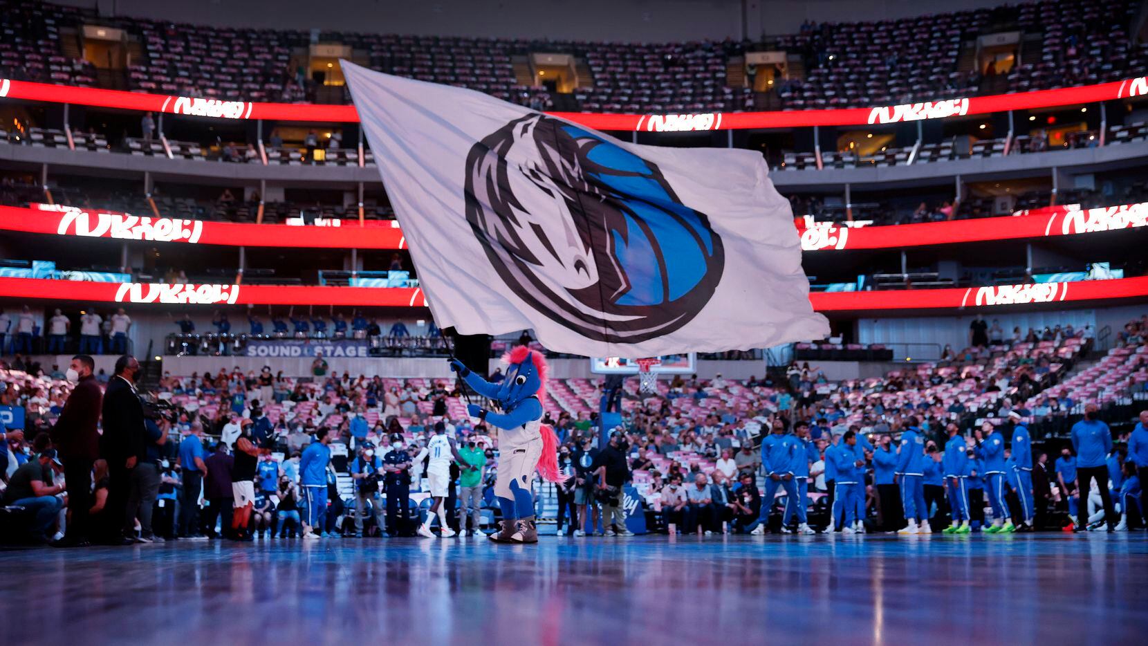 Dallas Mavericks mascot Champ waves the team flag prior to player introductions before...