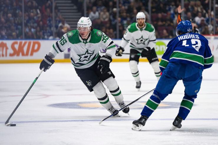 Dallas Stars' Matt Duchene (95) skates as Vancouver Canucks' Quinn Hughes (43) defends...