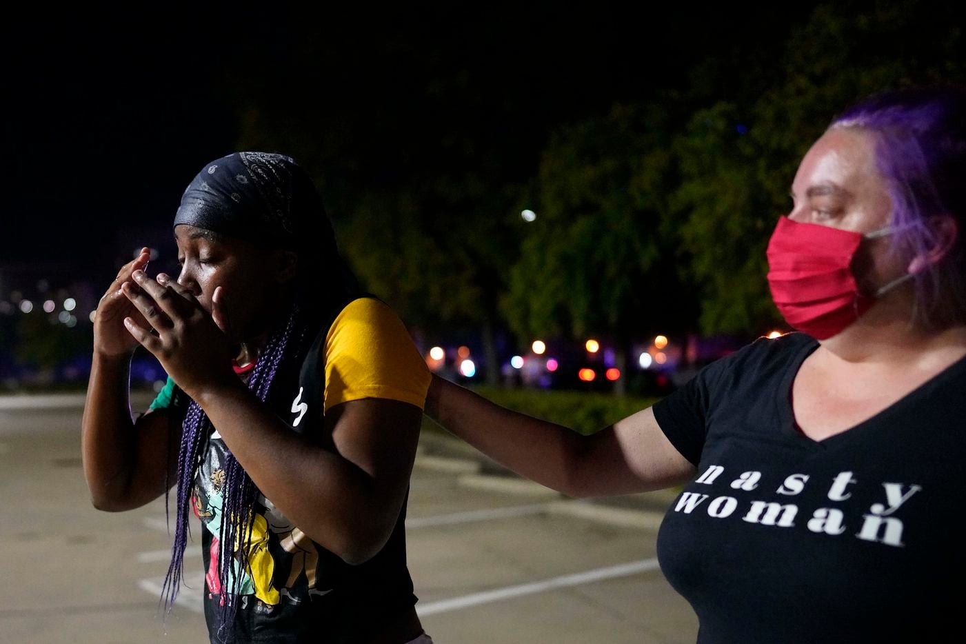 A protester is assisted after Dallas police attempted to disperse protesters with teargas at...
