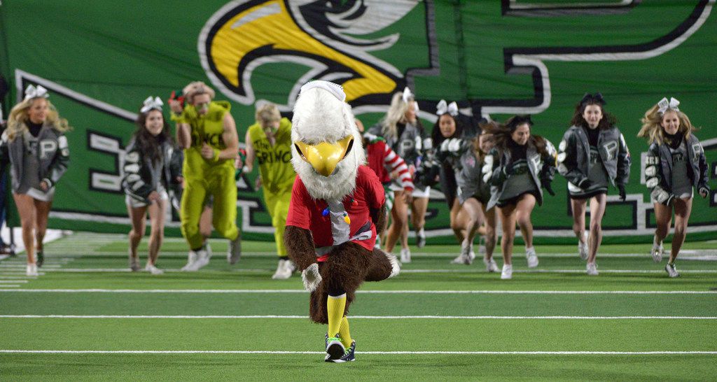 The Prosper Eagle leads the team onto the field before a high school football game between...