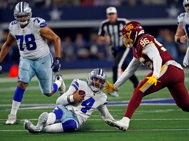 Dallas Cowboys quarterback Dak Prescott (4) slides safely for a first down, as Washington...