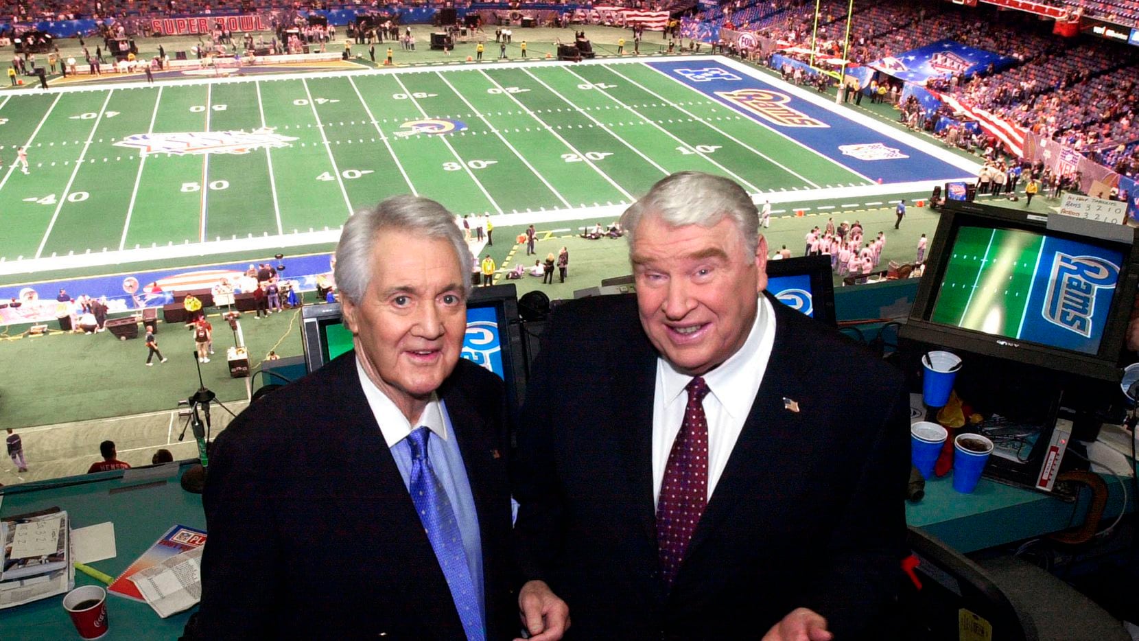 Fox broadcasters Pat Summerall, left, and John Madden stand in the broadcast booth at the...