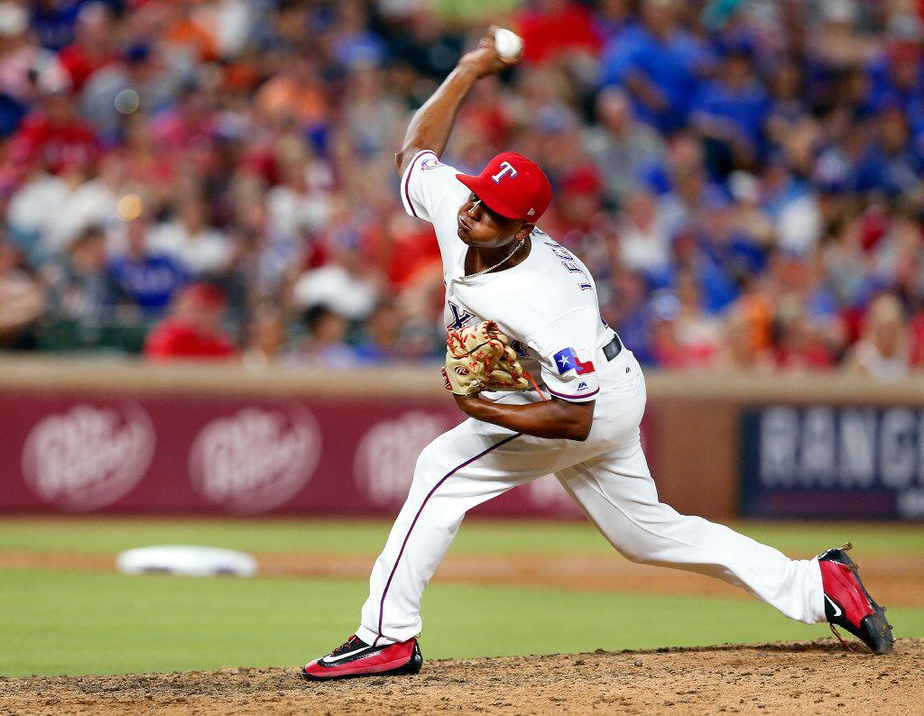 Texas Rangers relief pitcher Jose Leclerc (62) throws in the ninth inning against the...