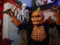 A scary display greets visitors along one of the walking paths at Screams Halloween theme...