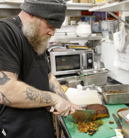 Chef Hank Storm chops vegan brisket made of seitan at VBQ Smokehouse in Fort Worth.