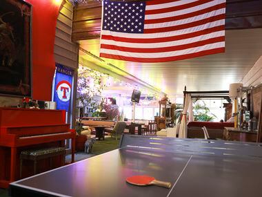 The game area sports a U.S. flag and Texas Rangers baseball signs plus a red piano.