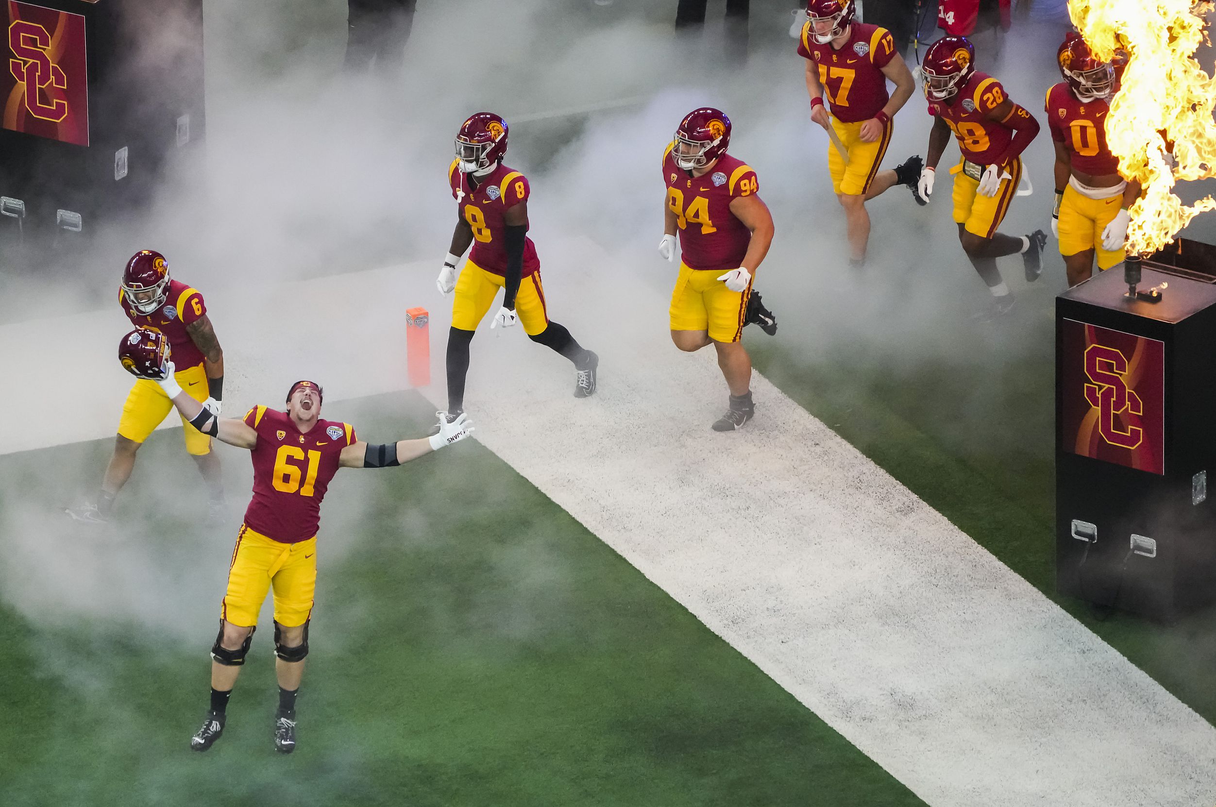 USC players, including offensive lineman Joe Bryson (61), take the field before the Cotton...