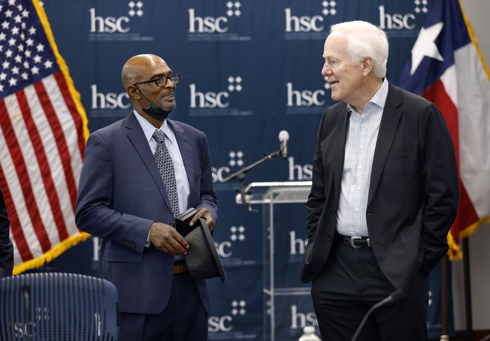 Johnny Pinchback (left), who was exonerated after 27 years in prison, speaks with Sen. John Cornyn.