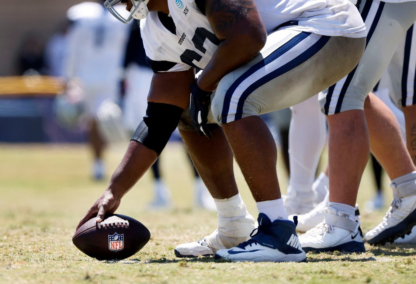Dallas Cowboys center Tyler Biadasz (63) prepares to snap a NFL football during training...