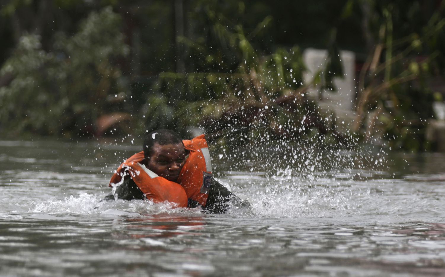 A rescuer falls into a flooded street in Havana, after the passing of Hurricane Irma in...