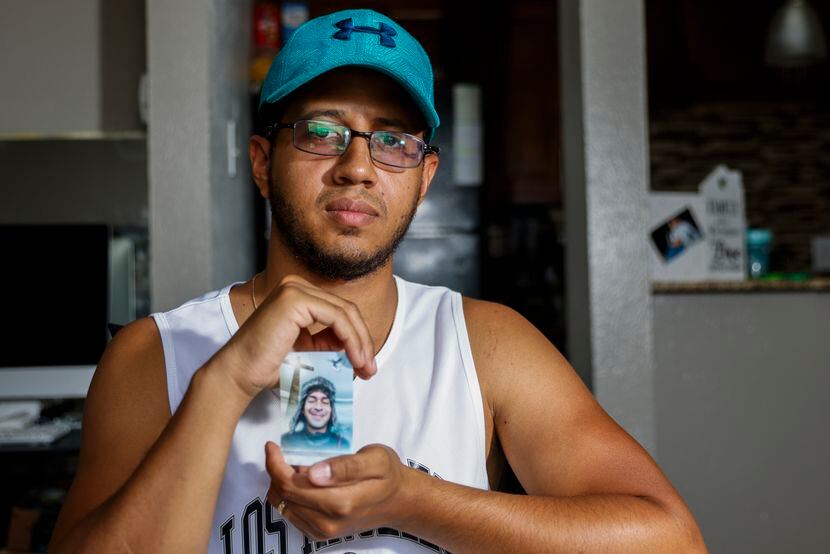 Daniel Seijas holds a photo of his longtime friend Elio Cumana, a victim of Allen Premium...