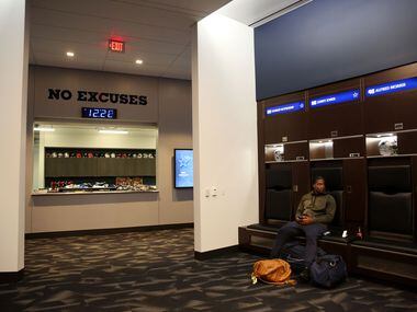 Dallas Cowboys linebacker Lenny Jones sits at his locker after cleaning it out at The Star...
