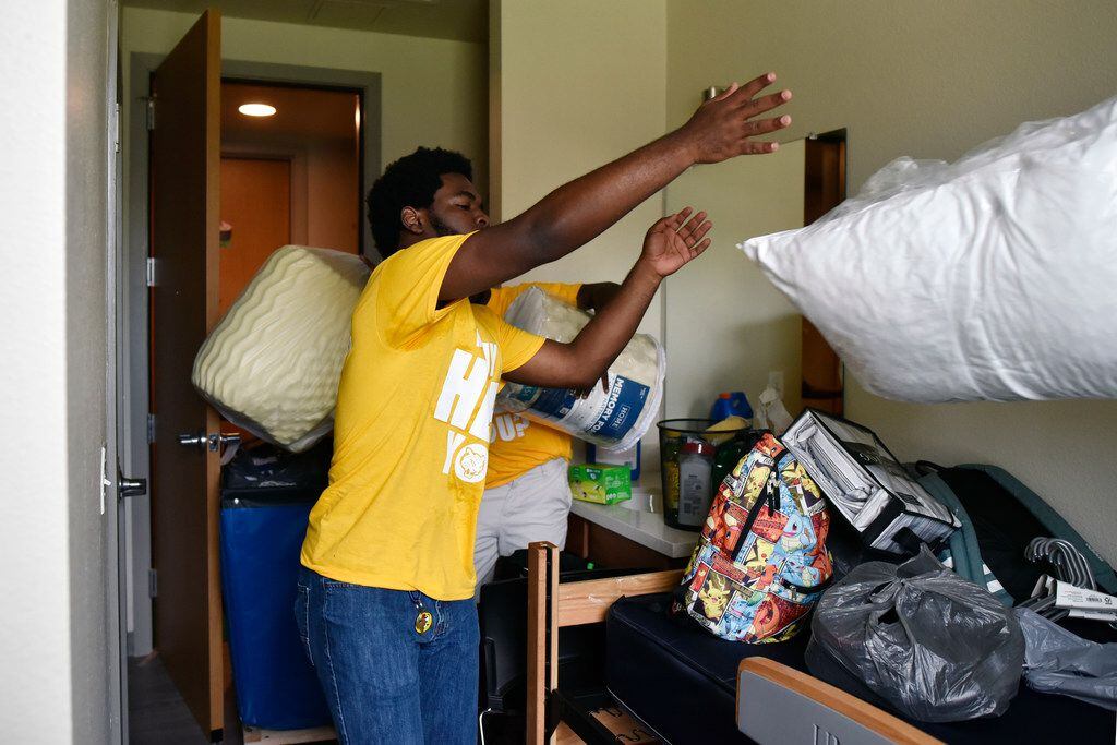 Sophomore Juwon Grant president of the Resident Hall Association  tosses a bag with a pillow...