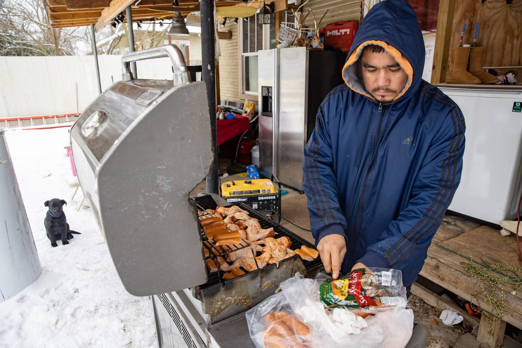 Franco Pompa grills chicken in his backyard at his East Dallas home on Wednesday, Feb. 17,...