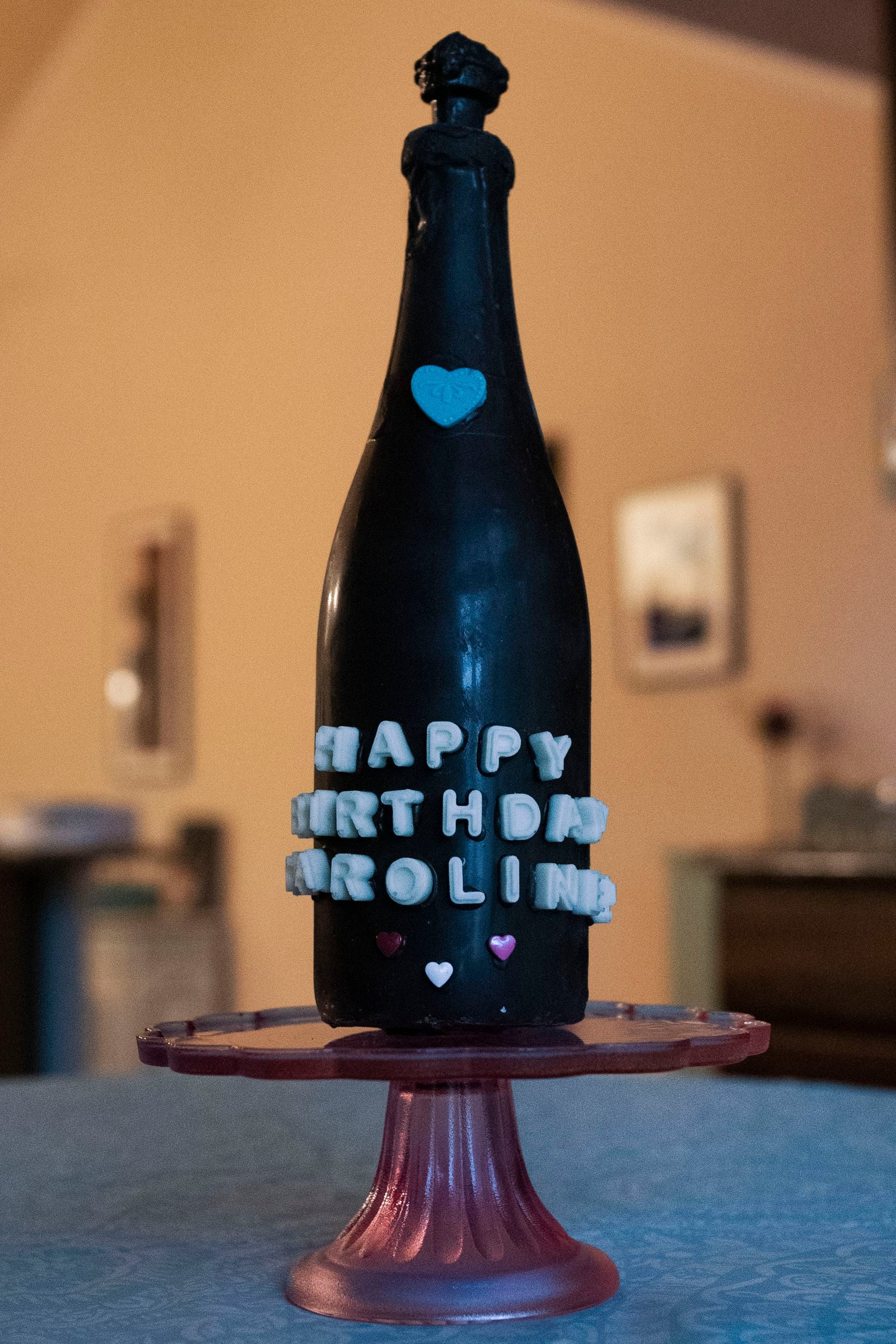 A chocolate wine bottle is one of the many items owner Jill Baethge, of Kaboom Chocolaka, makes for people to smash as they celebrate events.