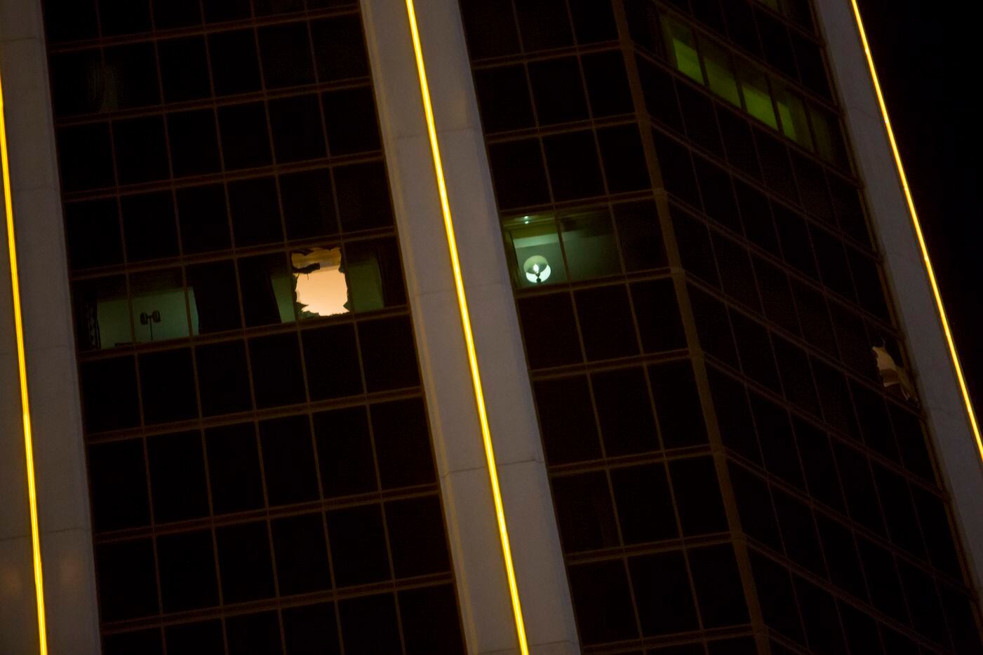 Broken windows in a 32nd-floor suite at the Mandalay Bay Resort and Casino, from which a...