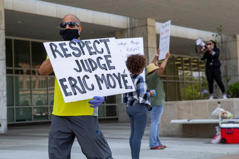Protesters gathered Monday outside the George Allen Civil Courthouse in downtown Dallas to...
