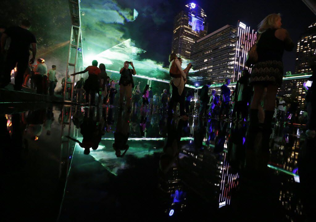 People take in the sights in the Dallas Arts District during Aurora on Friday, October 16,...