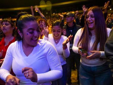 (From left) Yadenny Ocampo, Erica Ocampo and Giselle Figueroa, all from Dallas, dance to a...