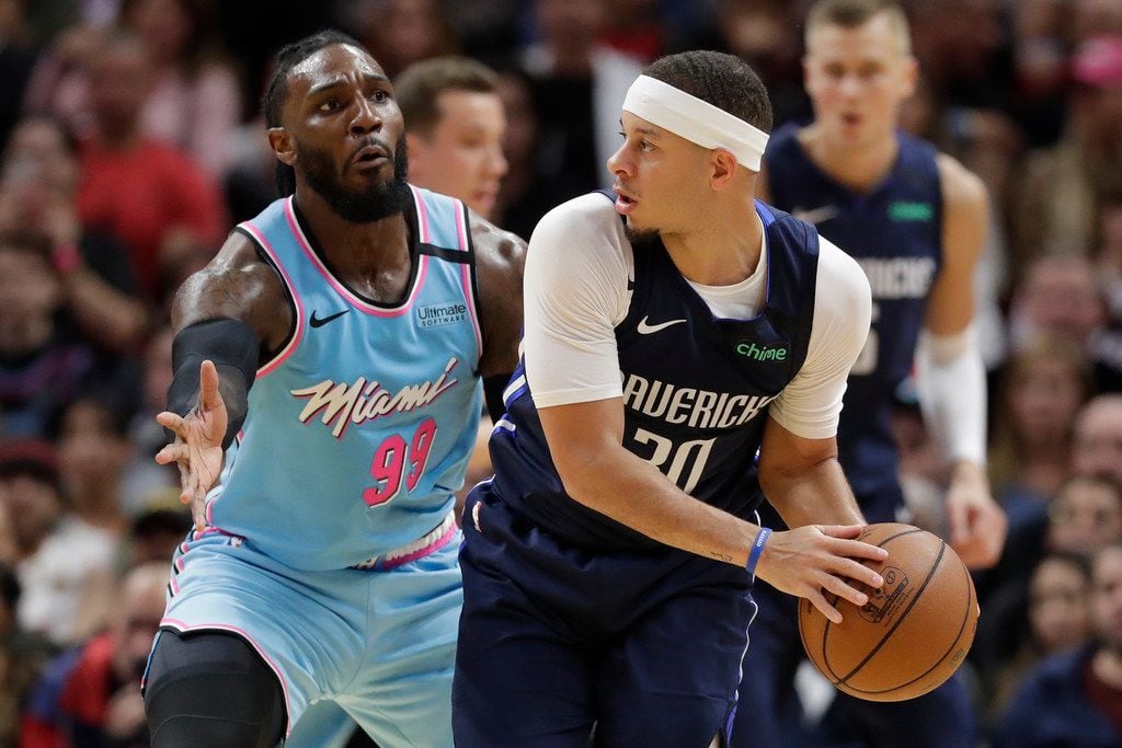 Dallas Mavericks guard Seth Curry (30) looks for an open teammate past Miami Heat forward...