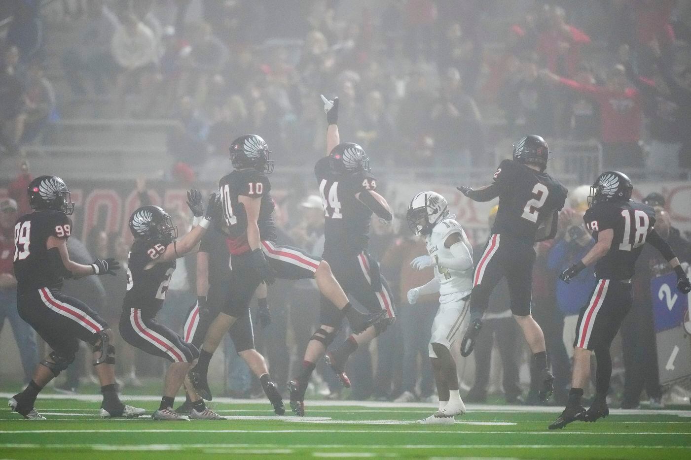 Argyle players celebrate an interception during the second half of a Class 5A Division II...