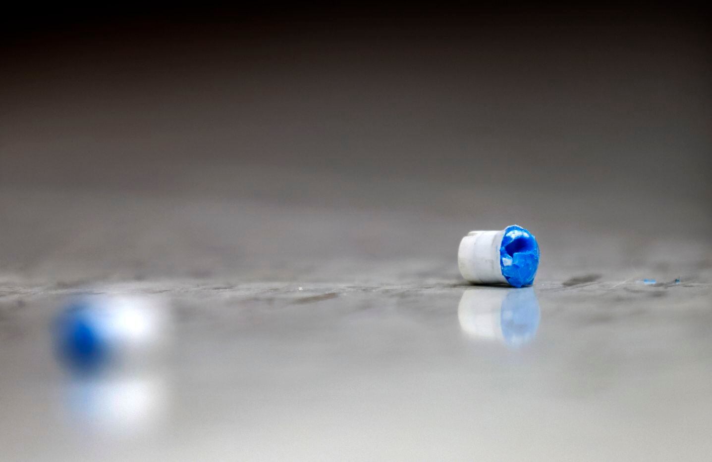Used soap-based marking cartridges lie on the floor during a Simunition training scenario...
