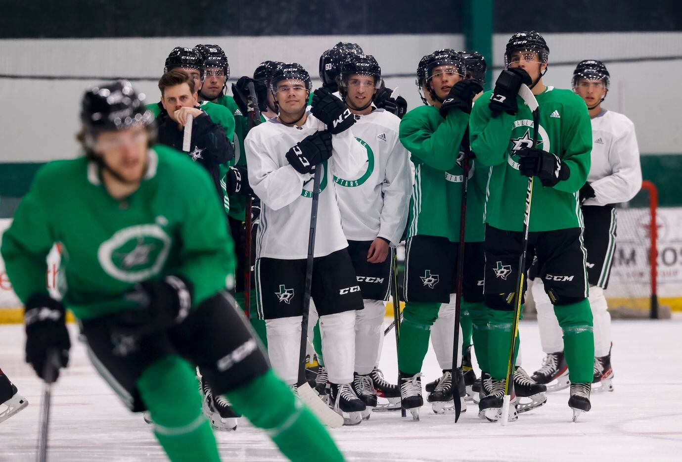 Prospects watch others perform drills during the Stars’ annual development camp Group A and...