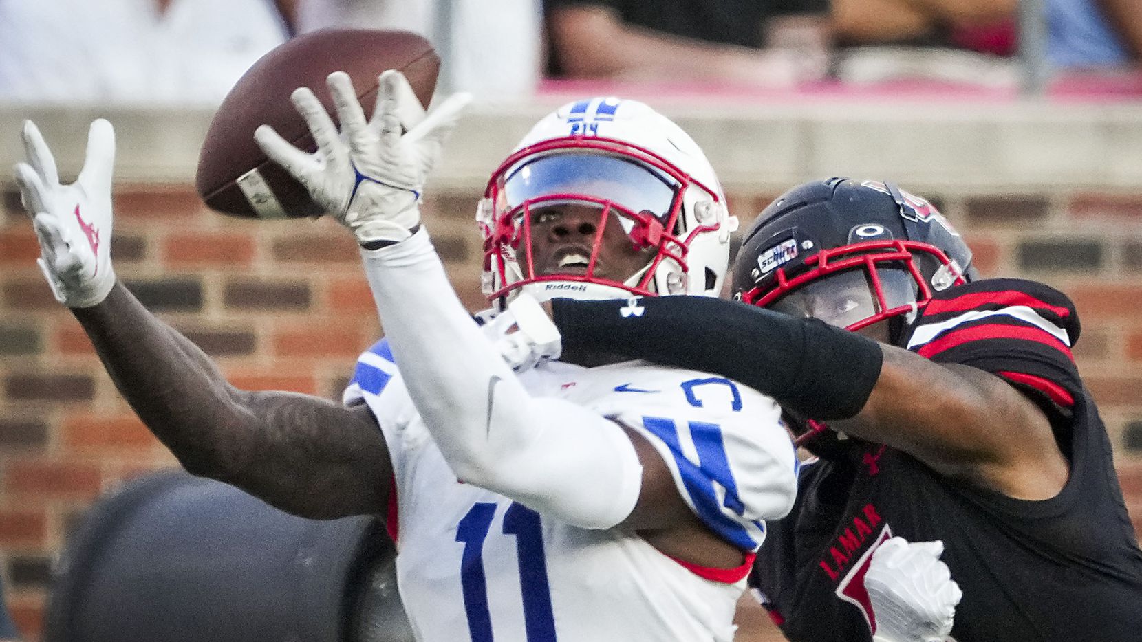Lamar Cardinals defensive back Damian Alexander (5) commits a pass interference penalty on a...