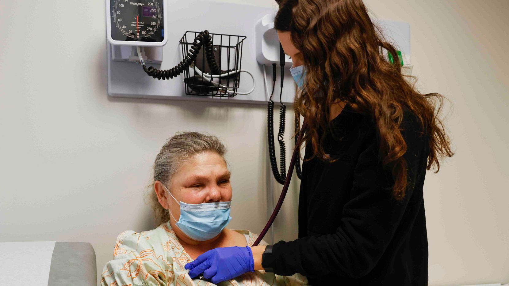 Patient Sara Diemer, left, gets checked by Anna Morongell, PA-C - Physician Assistant during...