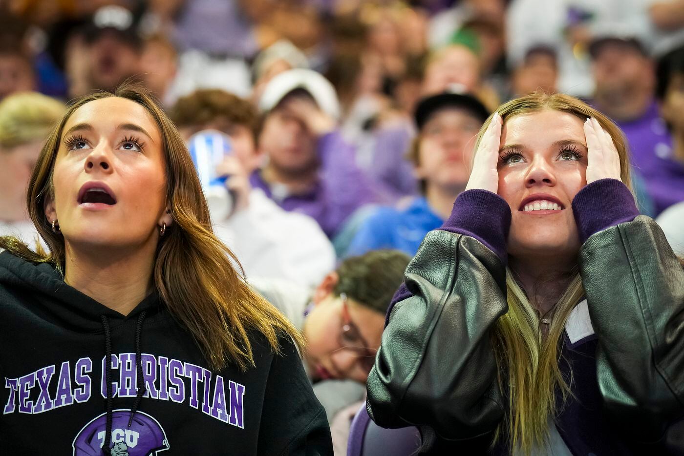 TCU fans Kit Nicoud (left) and Zoe Schiefer react after a first half Horned Frogs...