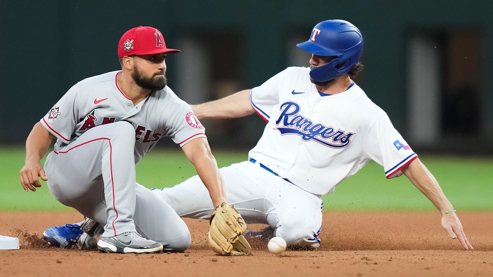 Texas Rangers left fielder Charlie Culberson steals second base ahead of the throw to Los...