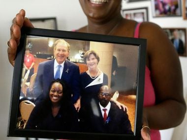In this June 30, 2017, photo, Shetamia Taylor holds a photo in Garland, Texas, of her and...