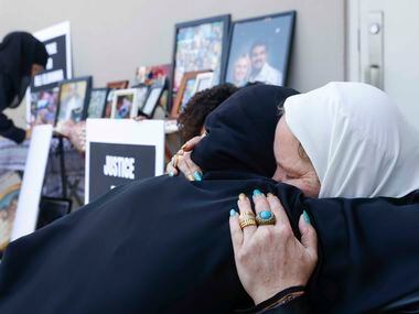Fatema Mohammed Hadi, left, embraces Stephanie Young Elbanna, the widow of Ali Elbanna, at...