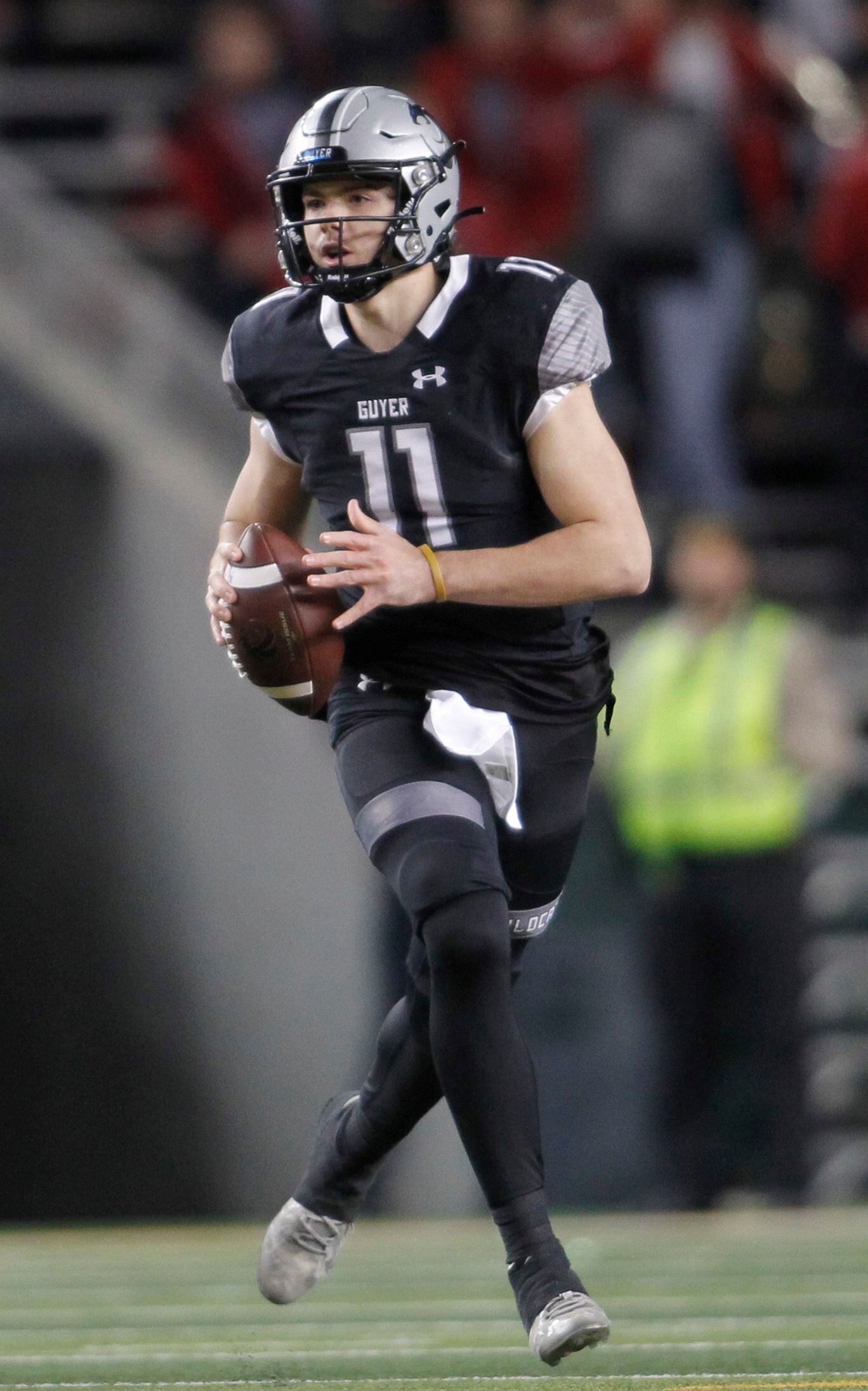 Denton Guyer quarterback Jackson Arnold (11) rolls out in search of a receiver during first...