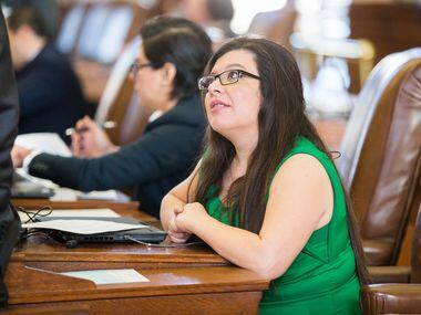 Rep. Mary González, D-El Paso, talks with another representative on the second day of the...