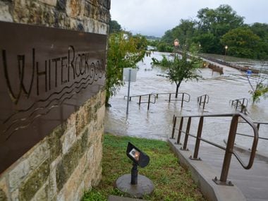 Water flooding out of the banks of White Rock Creek onto the Flagpole Hill Trail in Dallas...