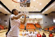 South Grand Prairie high’s Taliyah Parker cuts the net  following her team’s victory against...