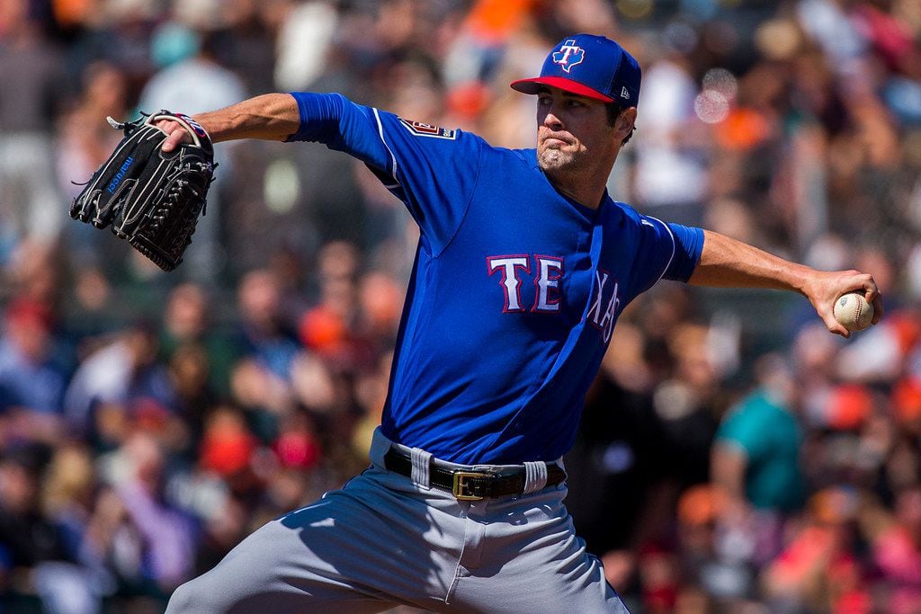 Texas Rangers pitcher Cole Hamels pitches during the first inning of a spring training...
