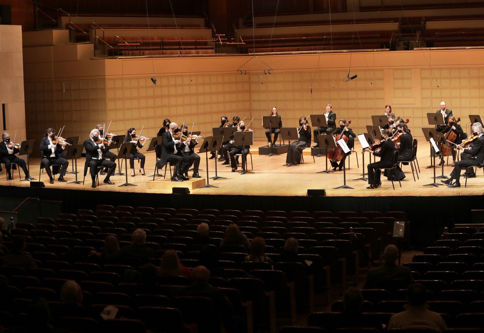 The Dallas Symphony Orchestra, led by concertmaster Alexander Kerr (center), performs at the...