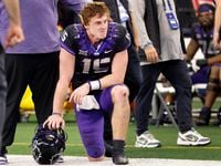 TCU Horned Frogs quarterback Max Duggan (15) takes a knee on the sideline after losing to...