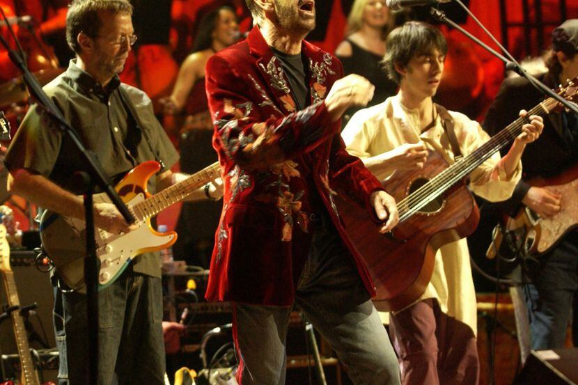 Ringo Starr sings with Eric Clapton (left) and Dhani Harrison (right) on guitars at The...