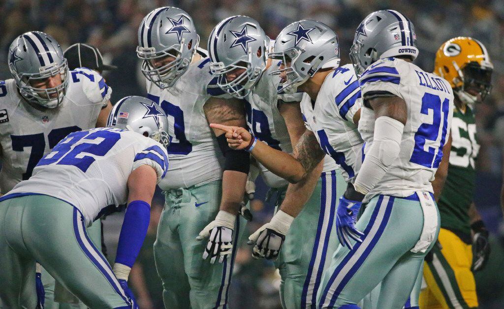 Dallas Cowboys quarterback Dak Prescott (4) calls the play in the huddle during Cowboys NFL...