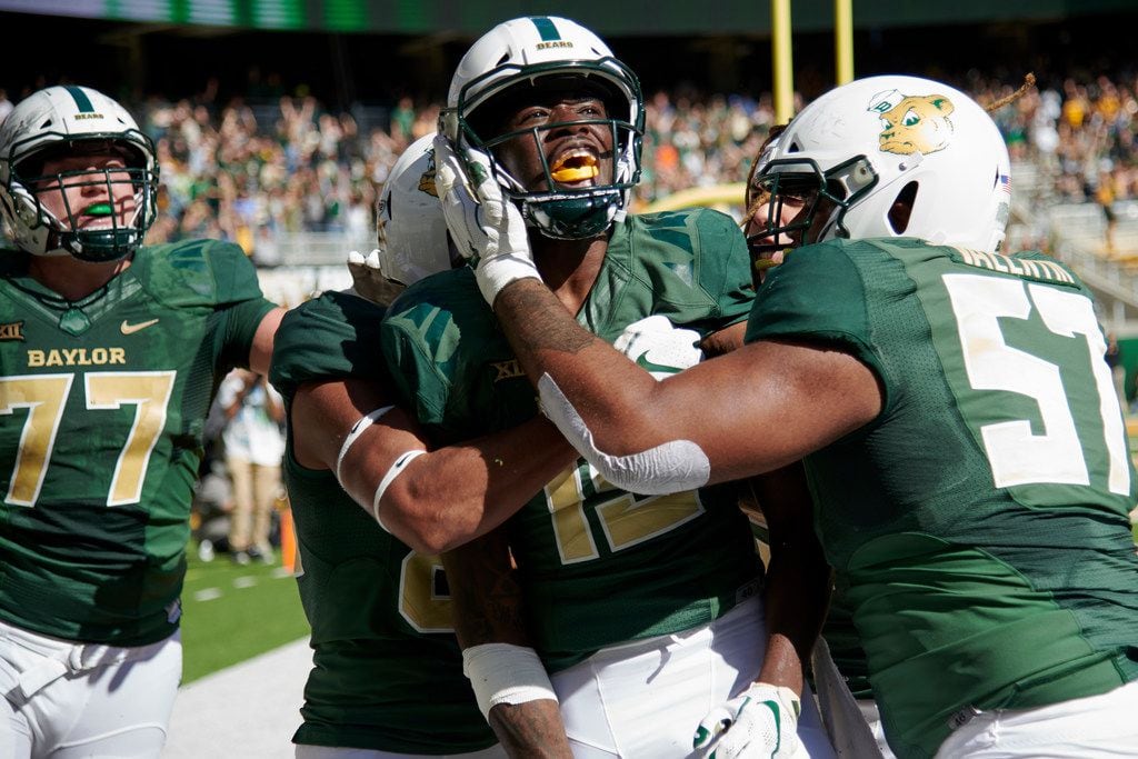 WACO, TX - NOVEMBER 3:  Denzel Mims #15 of the Baylor Bears celebrates with his teammates after scoring the game winning touchdown on a 6 yard reception against the Oklahoma State Cowboys during the second half of an NCAA football game at McLane Stadium on November 3, 2018 in Waco, Texas.  (Photo by Cooper Neill/Getty Images)
