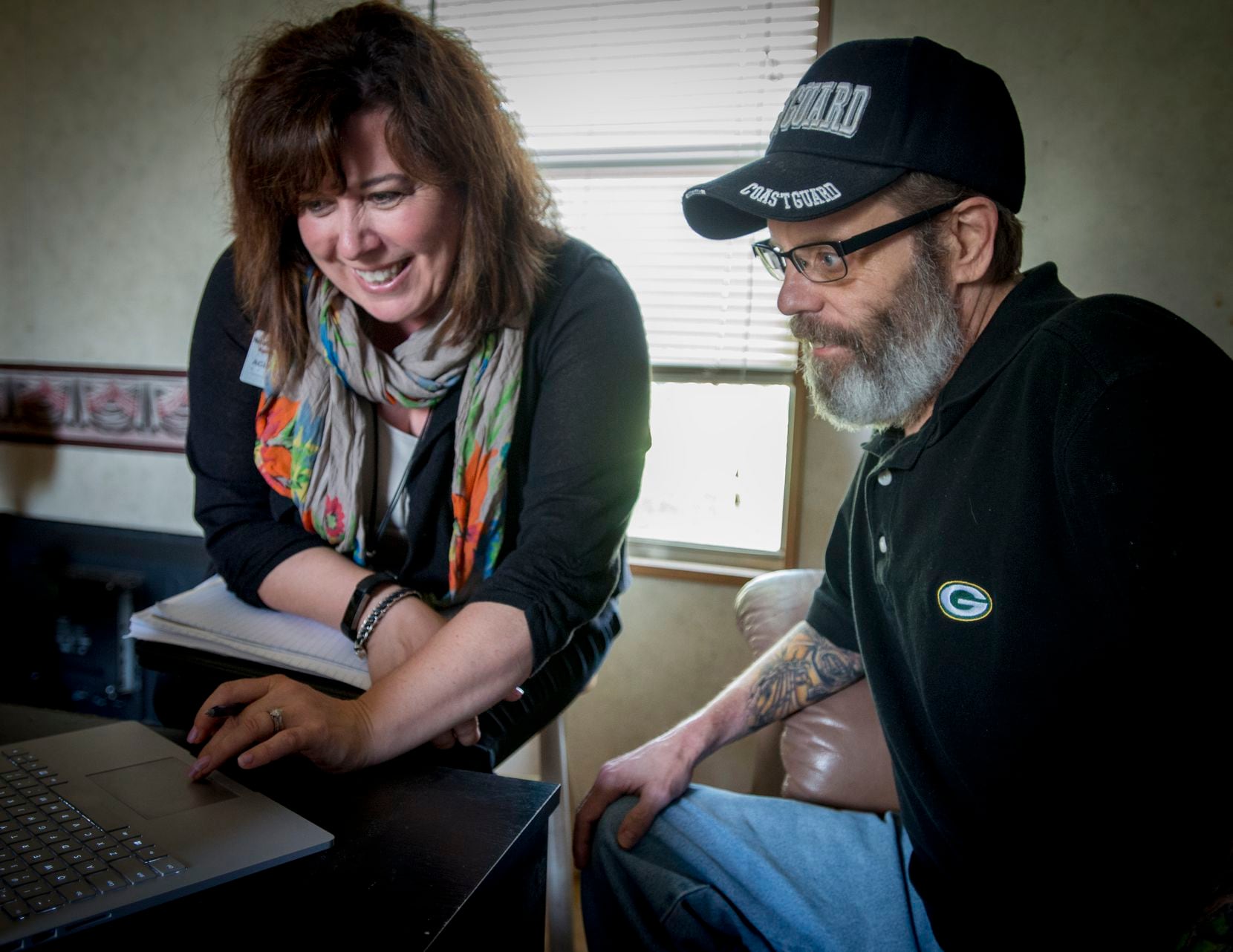 Geriatric care manager Nicole Kulas goes over personal health data with Stephen Kelly in his...