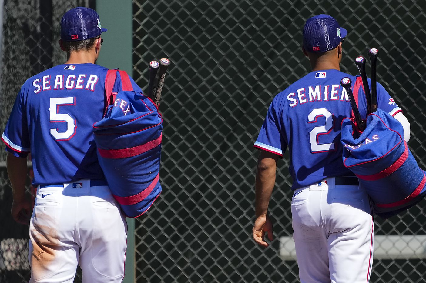 Texas Rangers infielders Corey Seager and Marcus Semien head for the clubhouse during the...