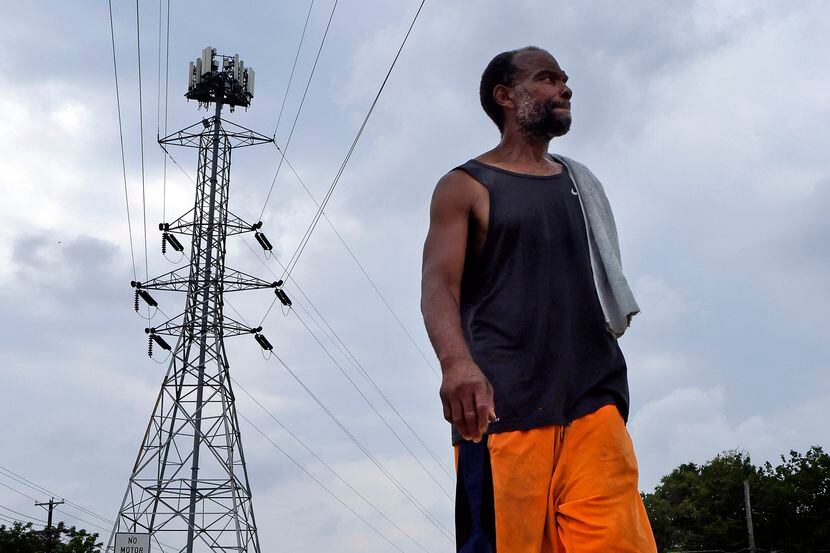 With a towel over his shoulder, Maurice Dickson takes a walk along the Oak Cliff Trail under...